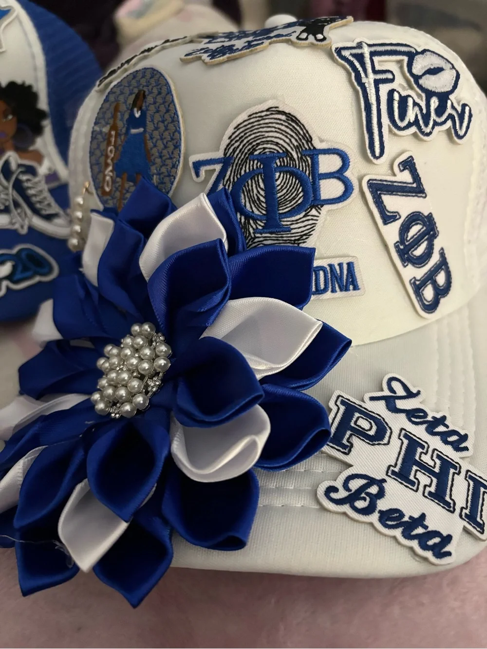 White Hat with Blue & White Flower Appliqué